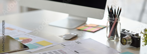 Foto Cropped shot of UI developer workspace with computer, stationery and paperwork