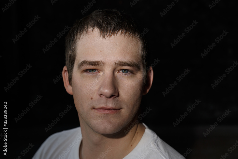Head shot of a handsome young unemployed man intensely and confidently looking at camera Head shot of a handsome young unemployed man intensely and confidently looking at camera