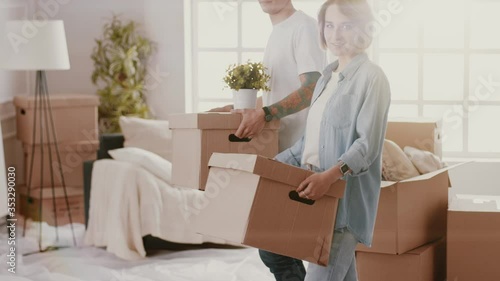 Excited Young Couple Unpacking Things, Opening Box And putting