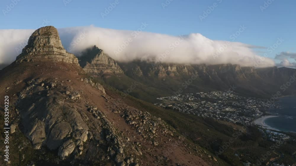 Drone shot of the iconic Lion's Head and Table Mountain of Cape Town. Camps bay is one of South Africa's most affluent neighborhoods. Drone shot of the iconic Lion's Head and Table Mountain of Cape Town. Camps bay is one of South Africa's most affluent neighborhoods.