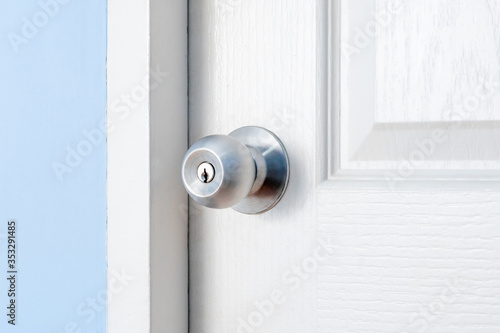 stainless door knob or handle on wooden white door © byjeng