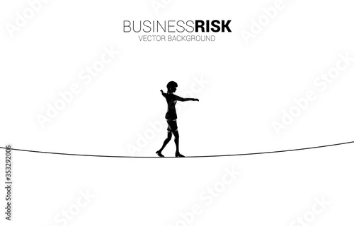 Silhouette of businesswoman walking on rope walk way.Concept for business risk and challenge in career path