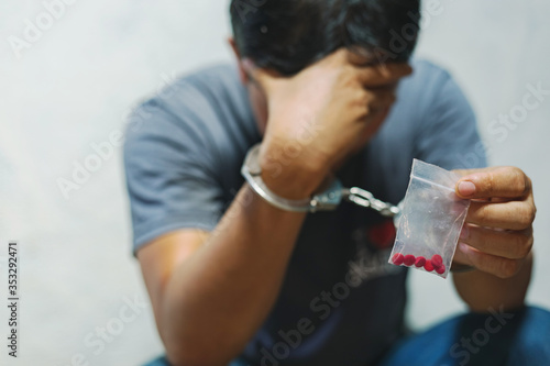 Tablou canvas Drug dealer under arrest confined with handcuffs and hands, sale of drugs is punishable by law