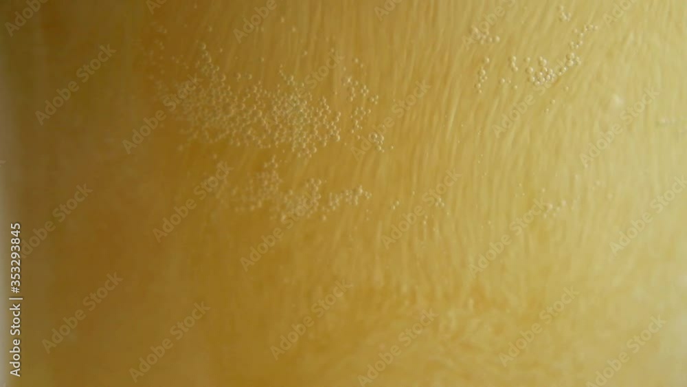 Pouring fresh beer in a glass. Cold drink beverage ready for appetizer, with bubbles and foam. Close up. Pouring fresh beer in a glass. Cold drink beverage ready for appetizer, with bubbles and foam. Close up.