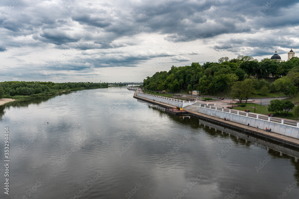 Beautiful view from the bridge to the Sozh River and the embankment in a green park. Gomel. Belarus