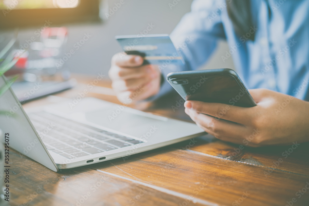 © photobyphotoboy - Woman holding credit cards and mobile phones are now shopping over the internet by paying by credit card.
