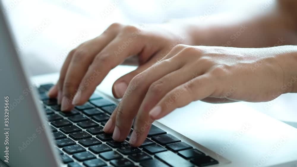 Hand of woman uses a notebook computer and she is typing text on the keyboard she work from home. technology concept. Hand of woman uses a notebook computer and she is typing text on the keyboard she work from home. technology concept.