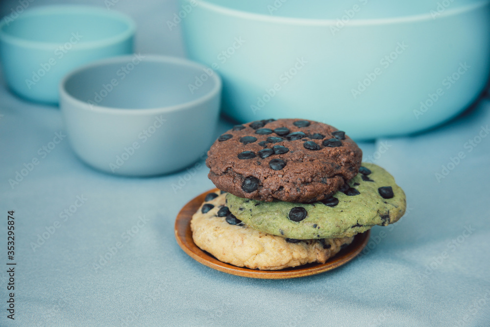 chocolate chunk cookies on a bright blue with bowl set as background. Food photography style chocolate chunk cookies on a bright blue with bowl set as background. Food photography style