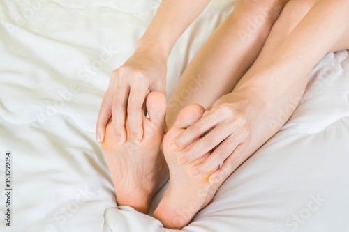 woman holding hand to Sole of the foot  Foot ache Health care concept selective focus