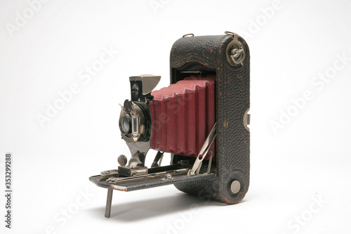 Vintage handheld medium format bellows film camera with viewfinder. Three-quarter view to left