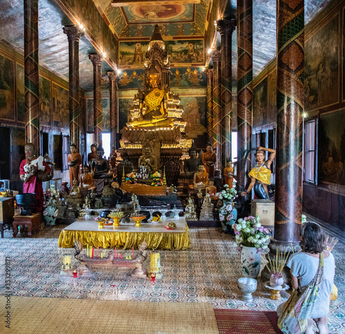 Buddhist in prayer inside Wat Phnom, Phnom Penh, Cambodia