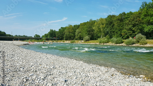 People enjoying the summer on the banks of the river Isar in the German city of Munich