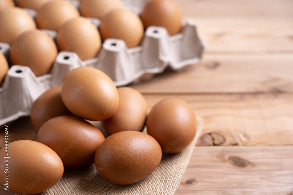 Brown Chicken Eggs on wooden background. and carton box Brown Chicken Eggs on wooden background. and carton box