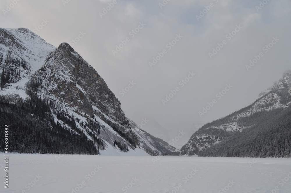Lake Louise in Canada, Totally Completely Entirely Frozen over with Fresh White Snow during Christmas, Surrounded by Mountains