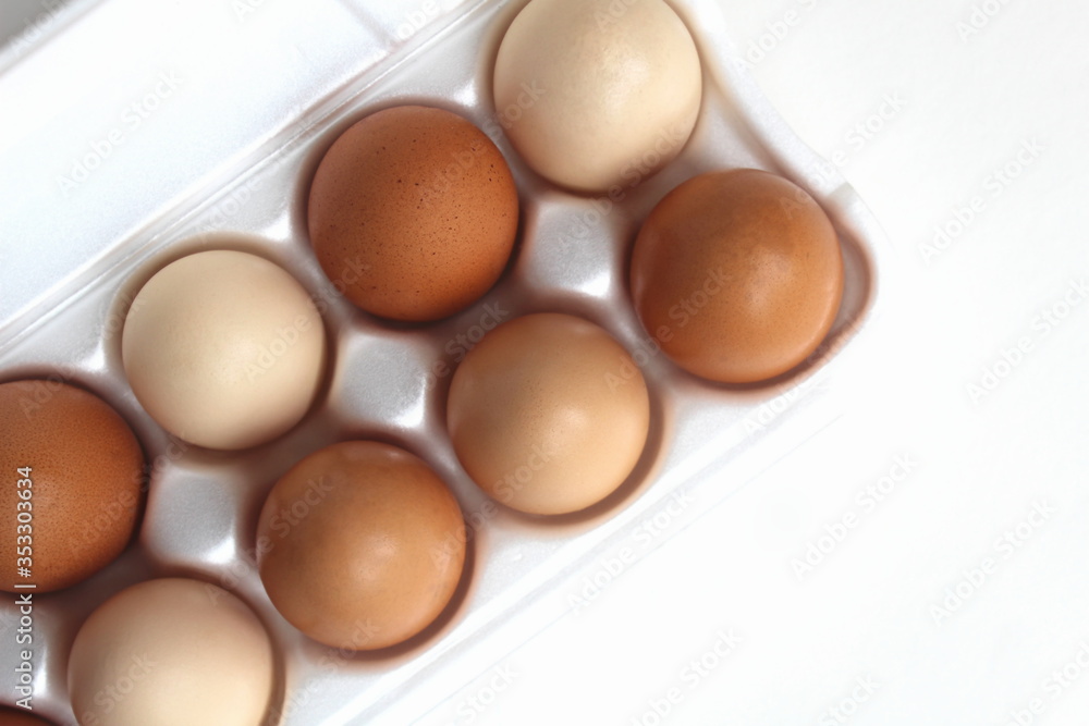 Tray of eggs with one on a white background Tray of eggs with one on a white background