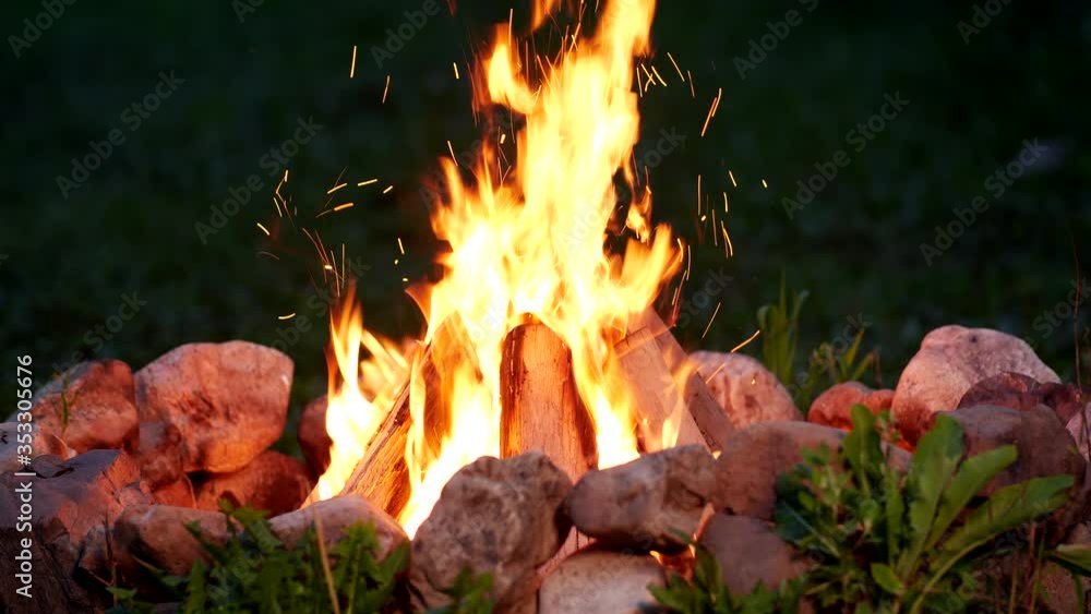 Graded shot of the campfire burning at night, filmed with a fast macro lens in UHD Graded shot of the campfire burning at night, filmed with a fast macro lens in UHD