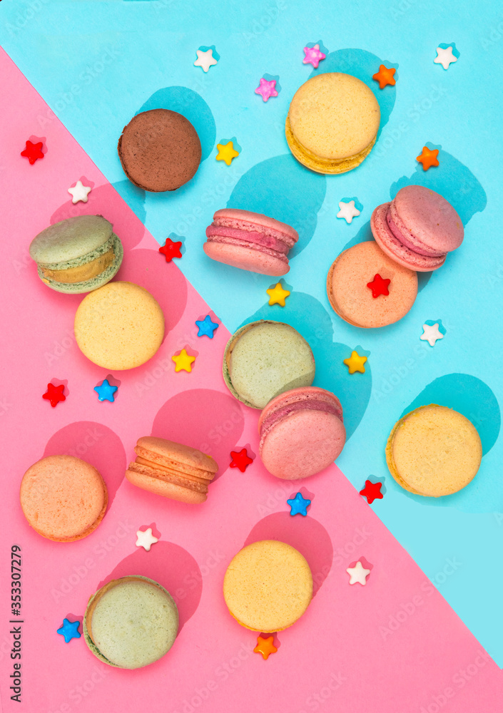 Macaroons cookies and candies multicolour placed on a pink and blue pattern background Food concept Macaroons cookies and candies multicolour placed on a pink and blue pattern background Food concept