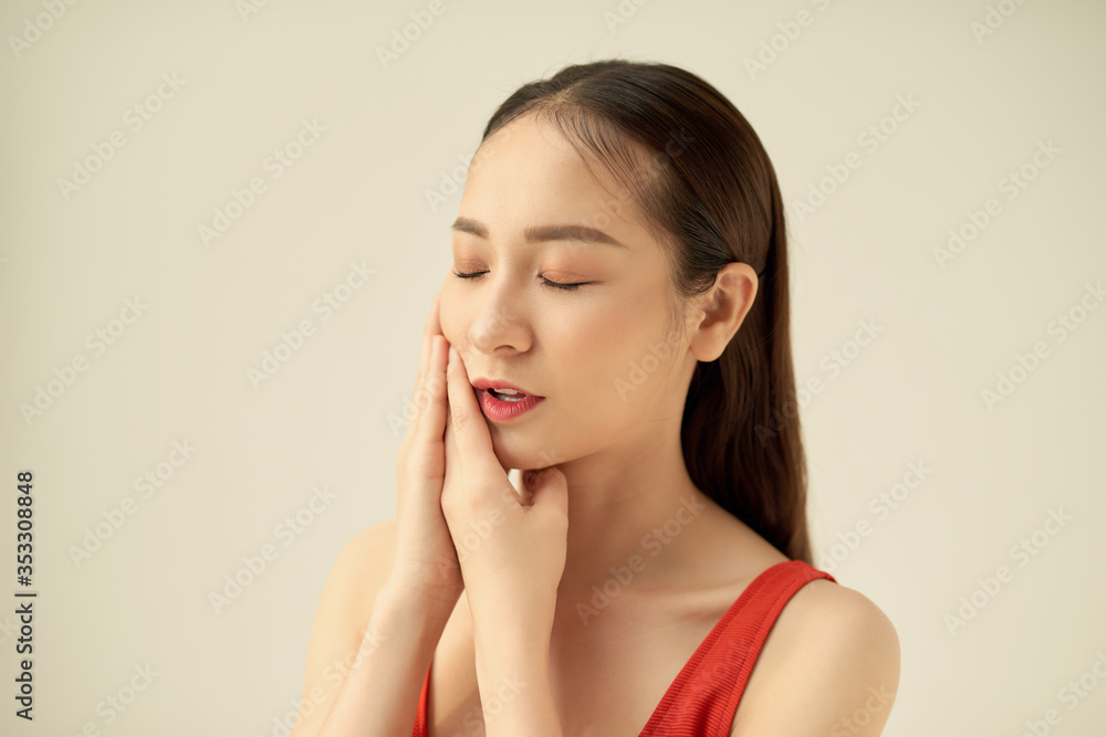 Young woman suffering from toothache on grey background Young woman suffering from toothache on grey background