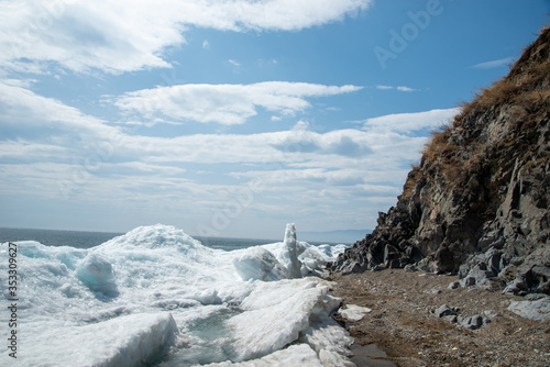 Wallpaper Mural Natural background. Change of seasons.Baikal Lake in May morning.Spring landscape.The view from the rocks in the foreground of a snow-white fragments of ice floes. Northern nature
 Torontodigital.ca