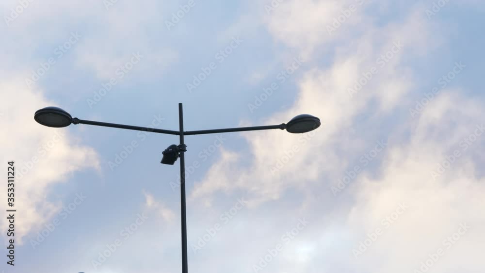 Fast moving clouds behind lamp post Fast moving clouds behind lamp post