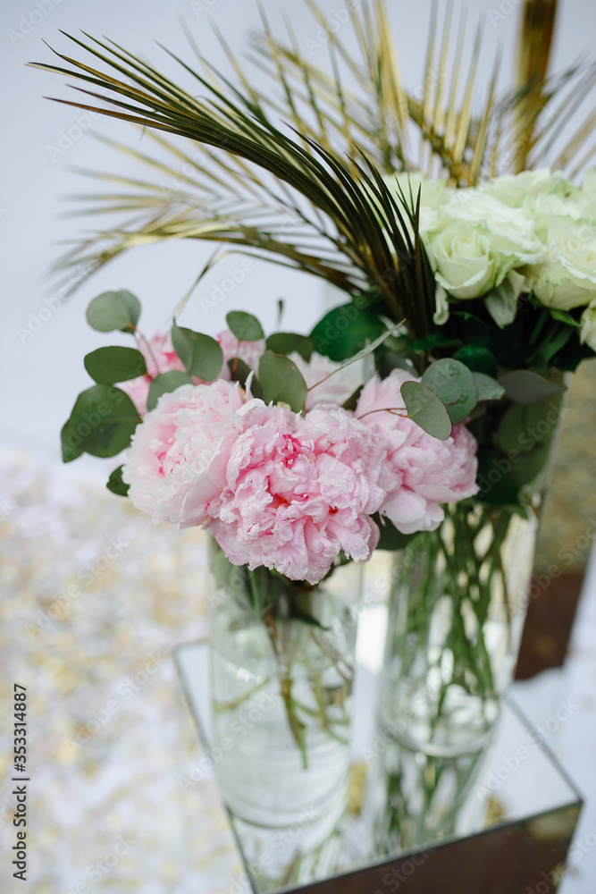 Pink peonies and roses in a wedding decor.