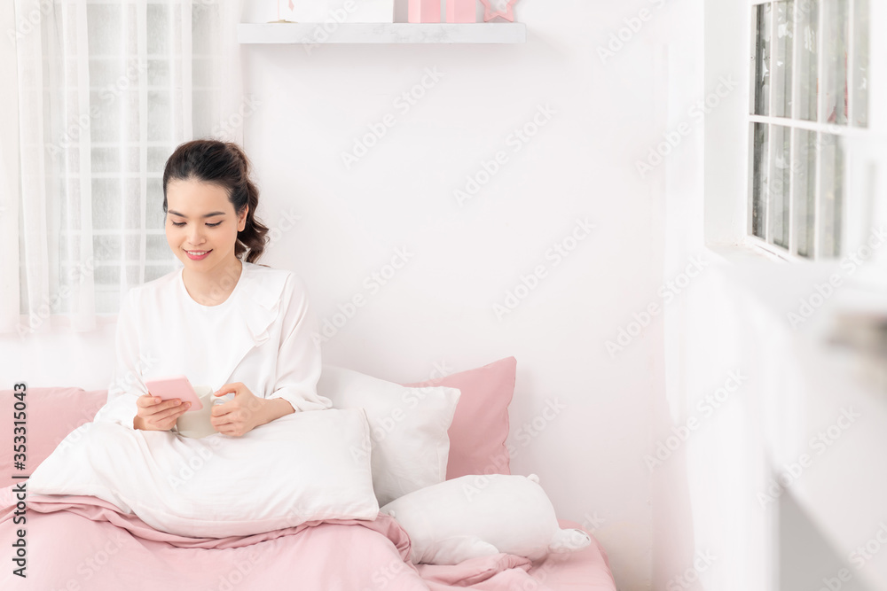 Asian woman Smile, relax with coffee and look at mobile phones. Asian woman Smile, relax with coffee and look at mobile phones.