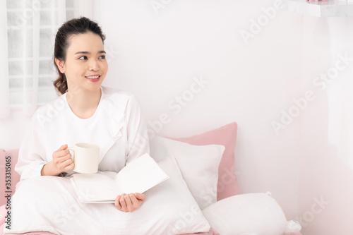 Young woman reading a book in morning