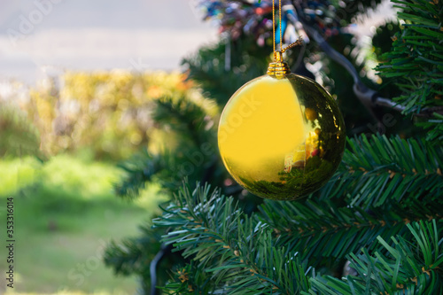 close up gold chrishmas ball on tree photo