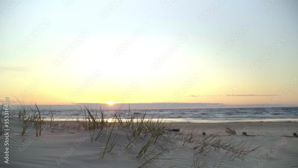 Follow Shot Over Sandy Empty Lilaste Beach With Golden Yellow Sunset Over The Baltic Sea. Slow Motion Follow Shot Over Sandy Empty Lilaste Beach With Golden Yellow Sunset Over The Baltic Sea. Slow Motion