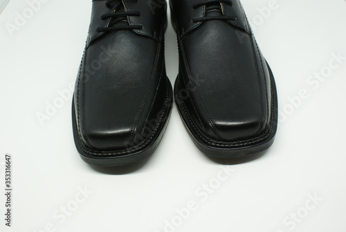 Elegant Black Leather Shoes on white background © ilyas