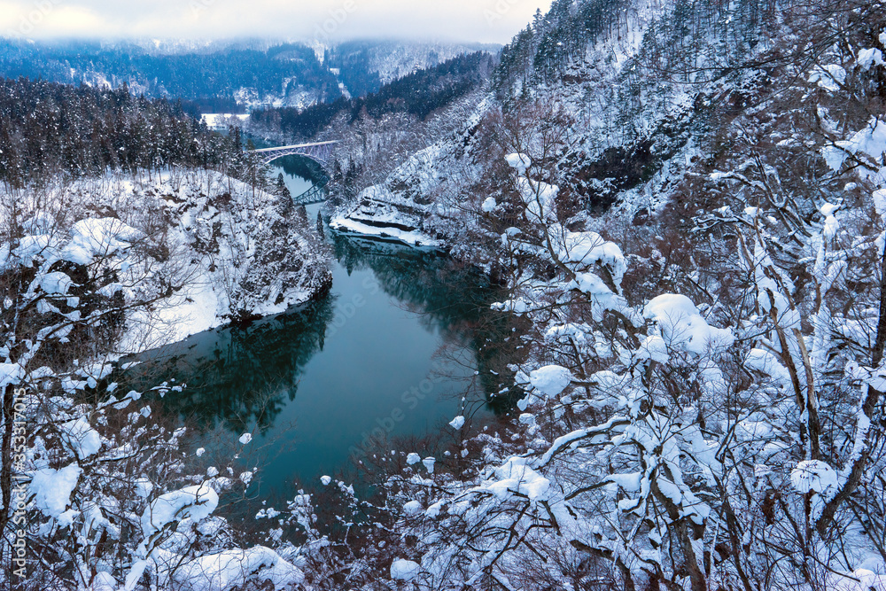 Tadami railway line and Tadami River in winter season at Fukushima