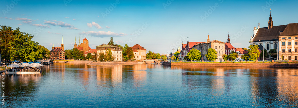 Panoramic summer cityscape of Wroclaw, Poland, Europe. Amazing  morninf view of famous Tumski island with cathedral of St. John on Odra river. Traveling concept background..