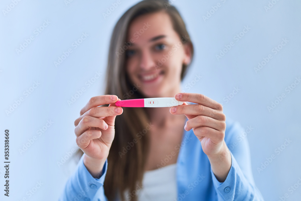 Happy joyful woman with a positive pregnancy test result. Planned and desired pregnancy Happy joyful woman with a positive pregnancy test result. Planned and desired pregnancy