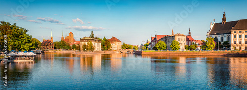 Panoramic summer cityscape of Wroclaw, Poland, Europe. Amazing morninf view of famous Tumski island with cathedral of St. John on Odra river. Traveling concept background..