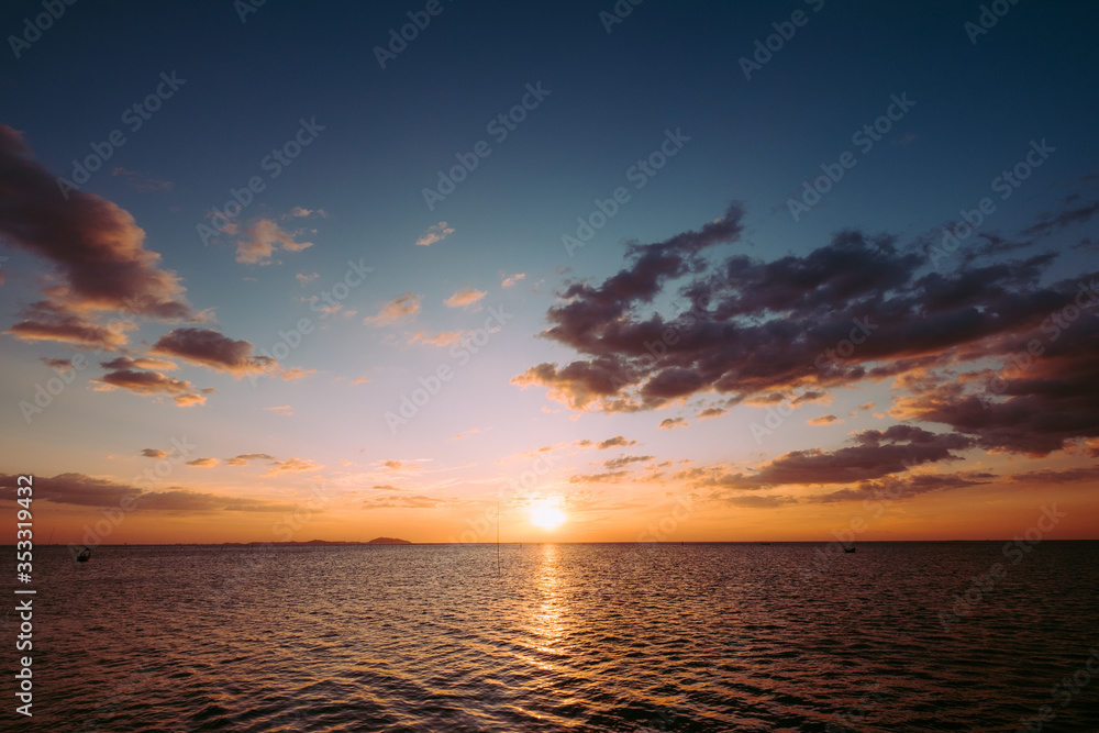 Midsummer beautiful sunset and sunrise sky reflection on sea ocean beach wave.