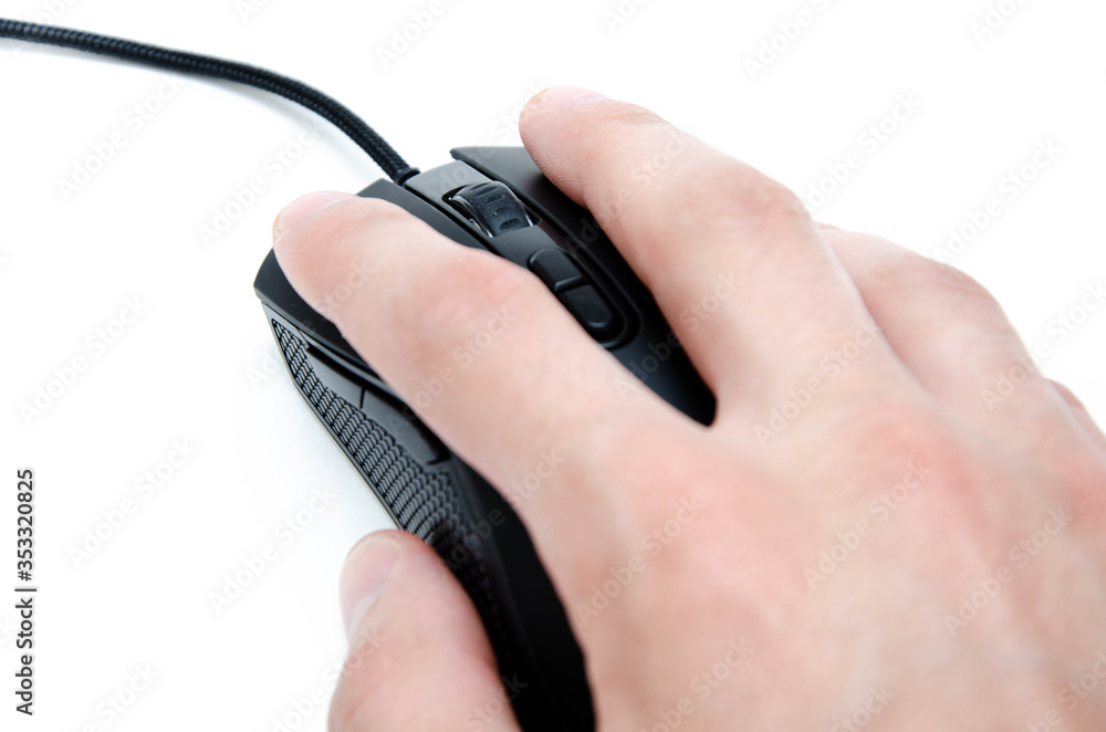 A male hand holds, controls, presses a wired black gaming mouse on a white background. The mouse is wired and wireless with additional side keys. Matte finish. Hand and mouse in macro and general plan A male hand holds, controls, presses a wired black gaming mouse on a white background. The mouse is wired and wireless with additional side keys. Matte finish. Hand and mouse in macro and general plan