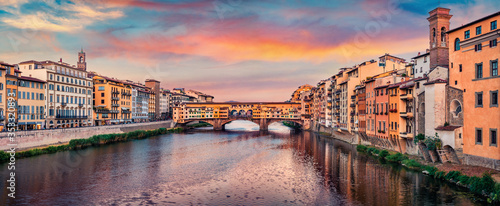 Splendid evening view of medieval arched river bridge with Roman origins - Ponte Vecchio over Arno river. Fantastic summer cityscape of Florence, Italy, Europe. Traveling concept background.