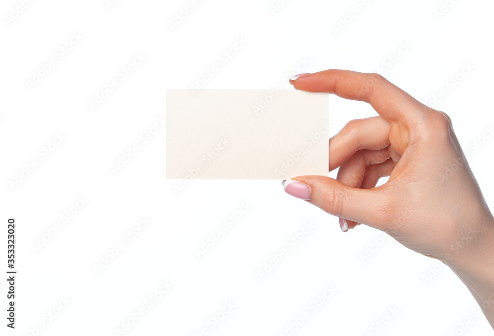 Obraz premium Beautiful female hand holding white business card on white background