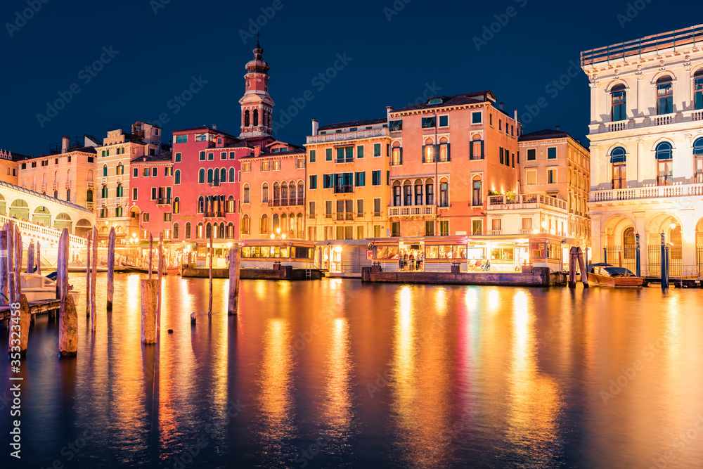 Marvelous night scene of famous Canal Grande. Illuminated houses and Rialto Bridge. Picturesque summer  cityscape of Venice, Italy, Europe. Traveling concept background.