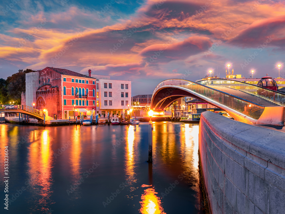 Fototapeta premium Illumitaned spring sunrise in Venice, Italy, Europe. Colorful morning view of Constitution Bridge. Magnificent Mediterranean seasacape. Traveling concept background.