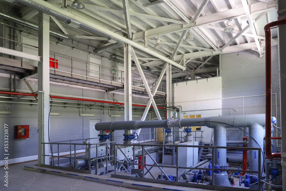 Modern pumping station at the water intake. Pipes, electric motors, pumping units. Modern pumping station at the water intake. Pipes, electric motors, pumping units.