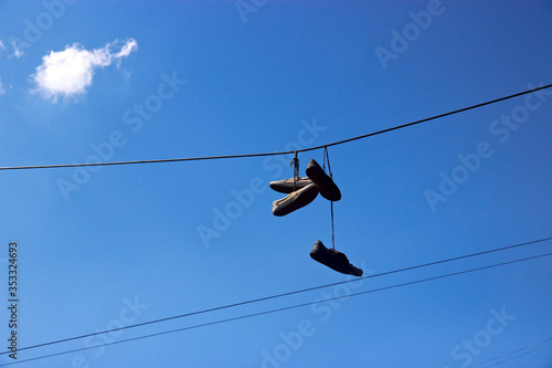 shoefiti old shoes hanging on wires