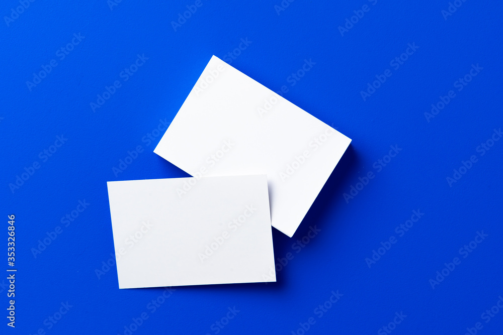 Blank white businesscards on classic blue background Blank white businesscards on classic blue background