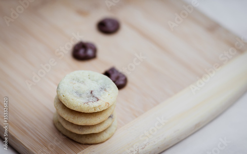 Fototapeta Naklejka Na Ścianę i Meble -  Stack of home made butter cookies filled with chocolate spread, handmade on wooden surface, close-up