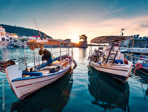 Adorable summer sunrise on Gulf of Corinth, Greece, Europe. Amazing morning scene of popular touristic destination - Nafpaktos port. Calm Ionian seascape. Traveling concept background.