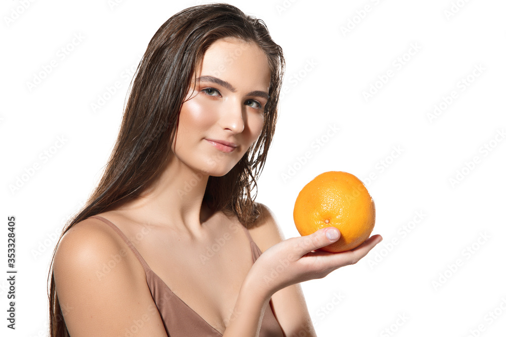 Eco-friendly. Close up of beautiful young woman with orange on white background. Concept of cosmetics, makeup, natural and eco treatment, skin care. Shiny and healthy skin, fashion, healthcare. Eco-friendly. Close up of beautiful young woman with orange on white background. Concept of cosmetics, makeup, natural and eco treatment, skin care. Shiny and healthy skin, fashion, healthcare.