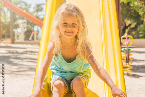 beautiful smiling little girl on a playground