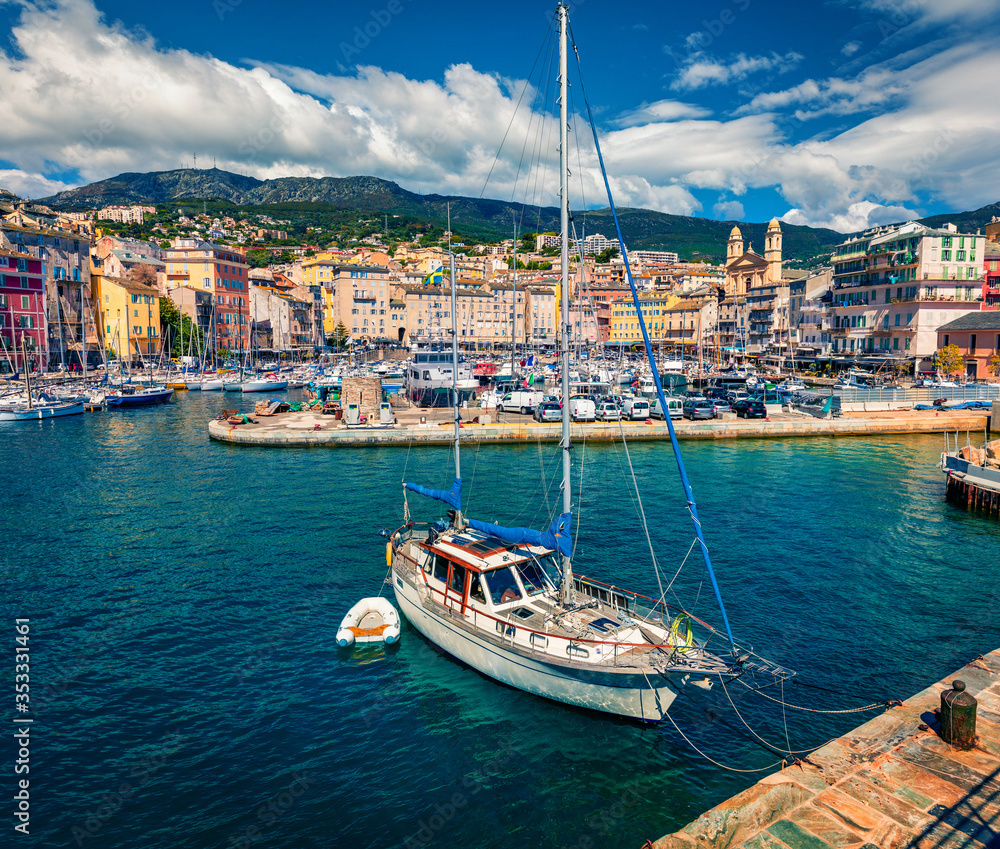 Fantastic summer cityscape of Bastia port. Marvelous morning view of Corsica island, France, Europe. Wonderful Mediterranean seascape with yacht and motorboat. Traveling concept background.