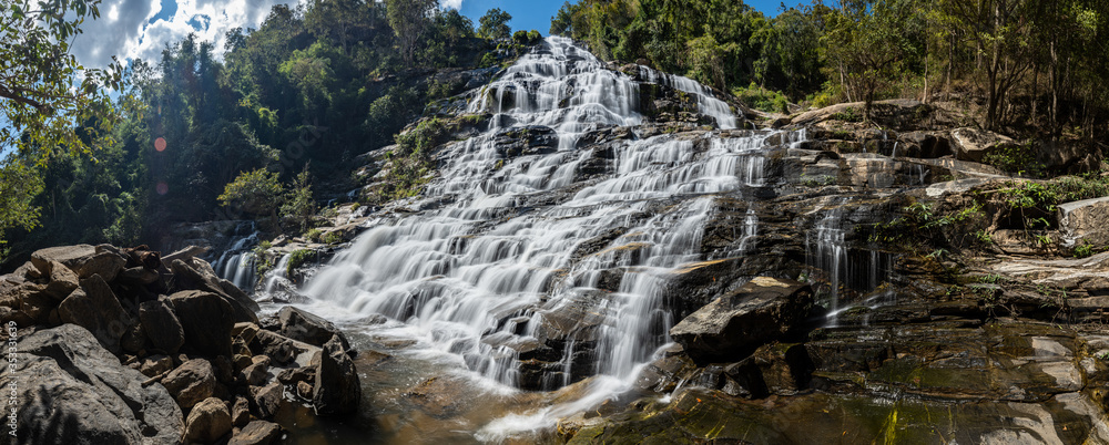Fototapeta premium Beautiful Smooth Waterfall with blue sky