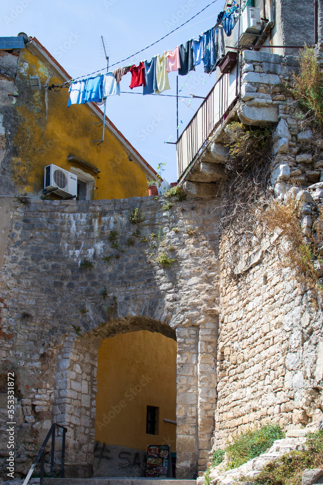 Stone arch in the walls of the old town of Porec (Parenzo), in the Istrian Peninsula, Croatia